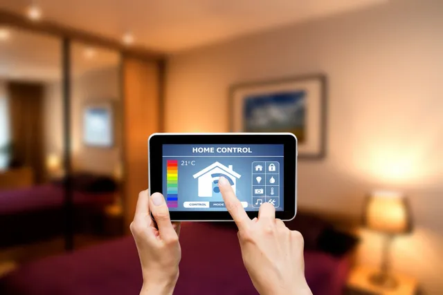 Person controlling smart home devices via a tablet app.